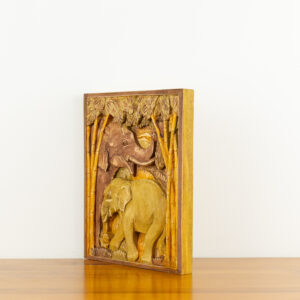 Intricate hand-carved wood wall relief of elephants in a forest by Sunflower Arts and Crafts for BISO.