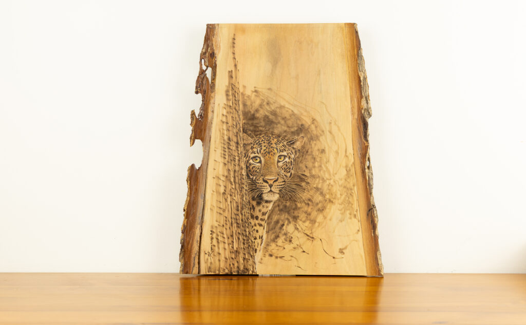 Hand-burned leopard wood art by Luvi Arts for BISO — pyrography on a live-edge timber slab