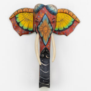 Front-facing hand-painted elephant wall sculpture, red and yellow floral ears, natural wood carving for BISO Heritage Collection.