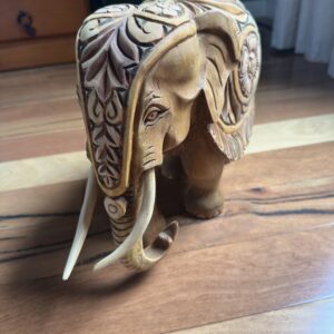 Intricate floral carving on wooden elephant sculpture