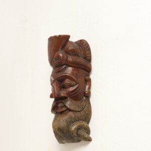 Handcrafted Sri Lankan wooden reclining figure with smoked finish and hand-painted natural colours