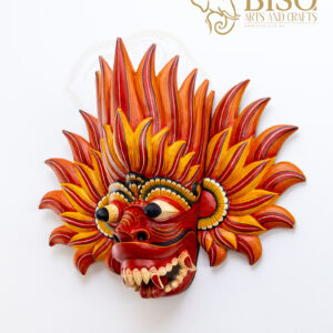 Angled view of Sri Lankan Gini Raksha mask with carved flame details