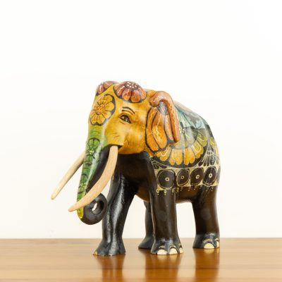 Traditional hand-painted Sri Lankan wooden elephant statue with floral motifs and tusks.