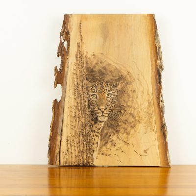 Hand-burned leopard wood art by Luvi for BISO - Pyrography on live-edge timber slab.