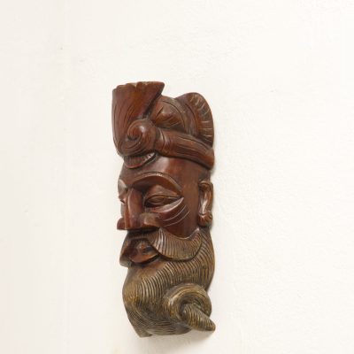 Handcrafted Sri Lankan wooden reclining figure with smoked finish and hand-painted natural colours